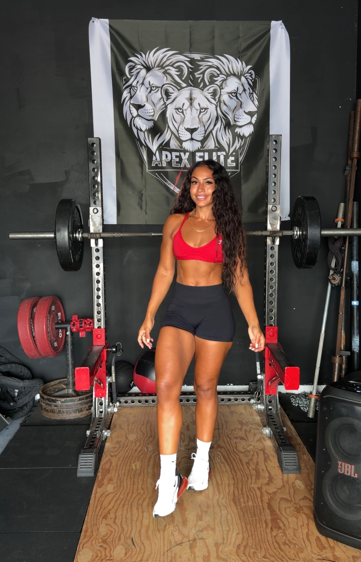 LabellaBeast founder and coach standing in front of a squat rack
